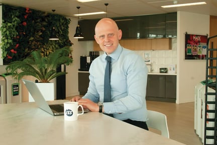 Web_Desktop-Kevin Hosking sat at table